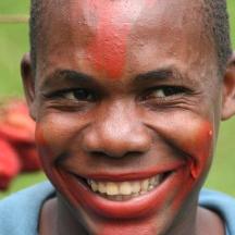 a young man with red paint on his face