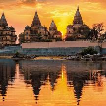 a group of buildings on the shore of a body of water