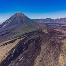 an aerial view of a mountain with the ocean