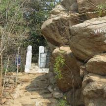 a sign on the side of a large rock