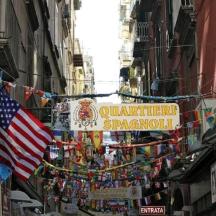 a street with an american flag and a sign