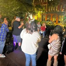 a group of people standing on a street at night