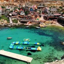 a boat in the water next to a small town