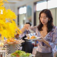 a woman is holding a plate of food