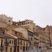a city street with buildings on the side of a hill