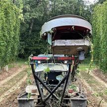 a tractor in the middle of a field of trees