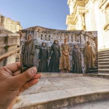 a hand holding a picture of a group of people