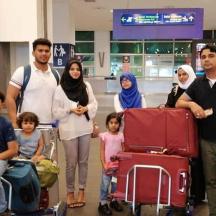 a group of people with luggage in an airport