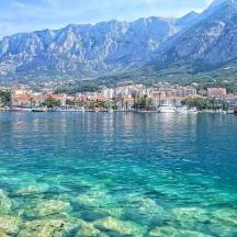 a large body of water with mountains in the background