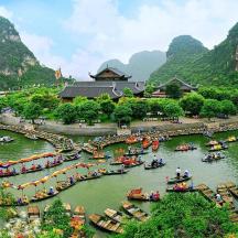 a group of people in boats in a river with mountains