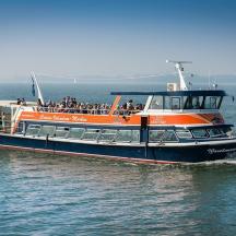 an orange and blue boat in the water