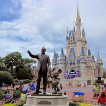 a statue of a man in front of a castle