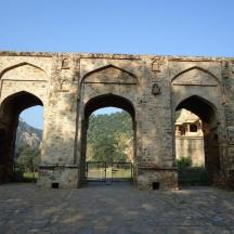 an old stone building with three arches