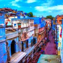 a view of a city with blue painted buildings