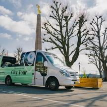a green and white van parked in a parking lot