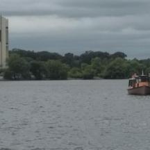 a boat on the water with a tower in the background