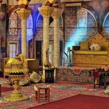 a large room with a bed and a rug