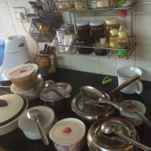 a kitchen counter with pots and pans and utensils