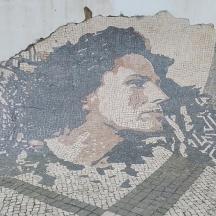a mosaic of a woman on the side of a wall