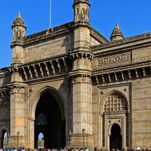 a large stone building with a crowd of people in front