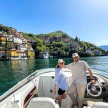 a man and woman standing on a boat on the water