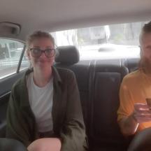 a man and a woman sitting in a car