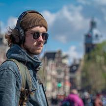 a man wearing headphones and a hat and sunglasses