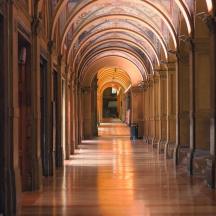 an empty hallway with arched ceilings in a building