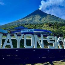 a large sign with a mountain in the background