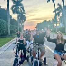 a group of people riding bikes down a street