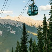 a gondola is flying over a mountain