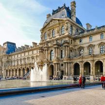 a large building with a fountain in front of it