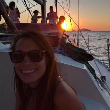 a woman in sunglasses is sitting on a boat