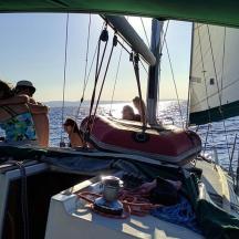 a group of people on a sail boat in the water