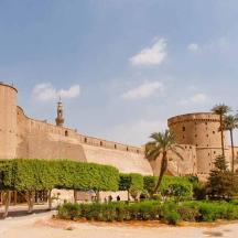 a large building with palm trees in front of it