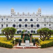 a large white building with a fountain in front of it