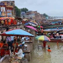 a group of people standing in the water with umbrellas