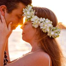 a man and a woman with a flower wreath