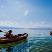 two people in kayaks on a large body of water