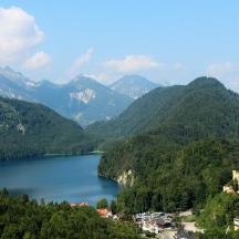 a view of a lake with a castle and mountains