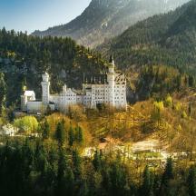 a castle on a hill in the middle of a mountain