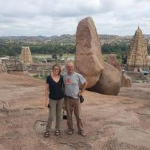 a man and woman standing in front of some rocks