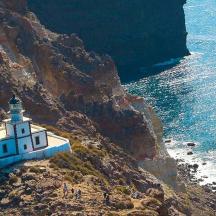 a lighthouse on the side of a cliff next to the ocean