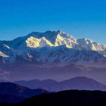 a mountain range with snow capped mountains in the distance
