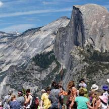 a group of people standing in front of a mountain