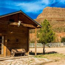 a small wooden building with a mountain in the background