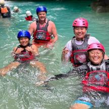 a group of people in the water on a raft