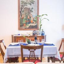 a dining room with a table and a painting on the wall