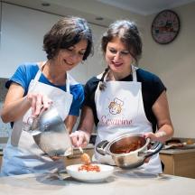 two women in a kitchen preparing food