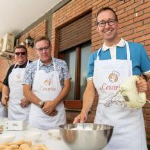 a group of men in a kitchen preparing food